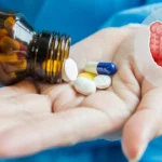 Hand holding pills highlighting gut health