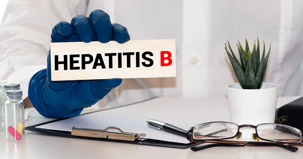 Doctor holding Hepatitis B sign on desk