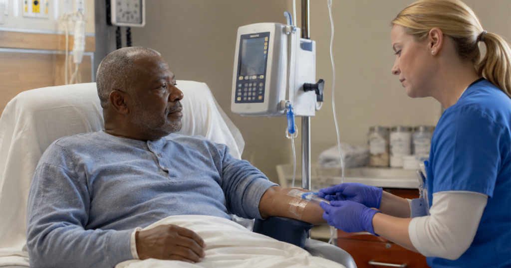 Nurse preparing IV treatment for a patient in a hospital room.
