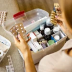 Woman placing pills in a medication lockbox